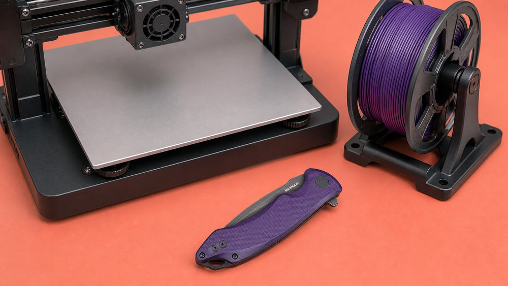 Closed purple HOPIAN Arcus knife beside an inactive desktop 3D printer