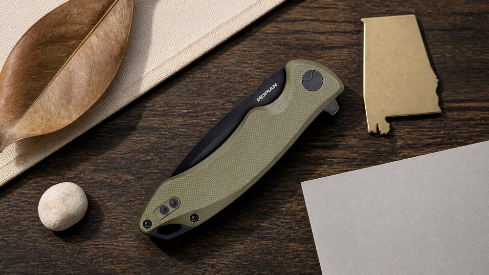 Closed green HOPIAN Arcus knife in a neutral Alabama legal research scene