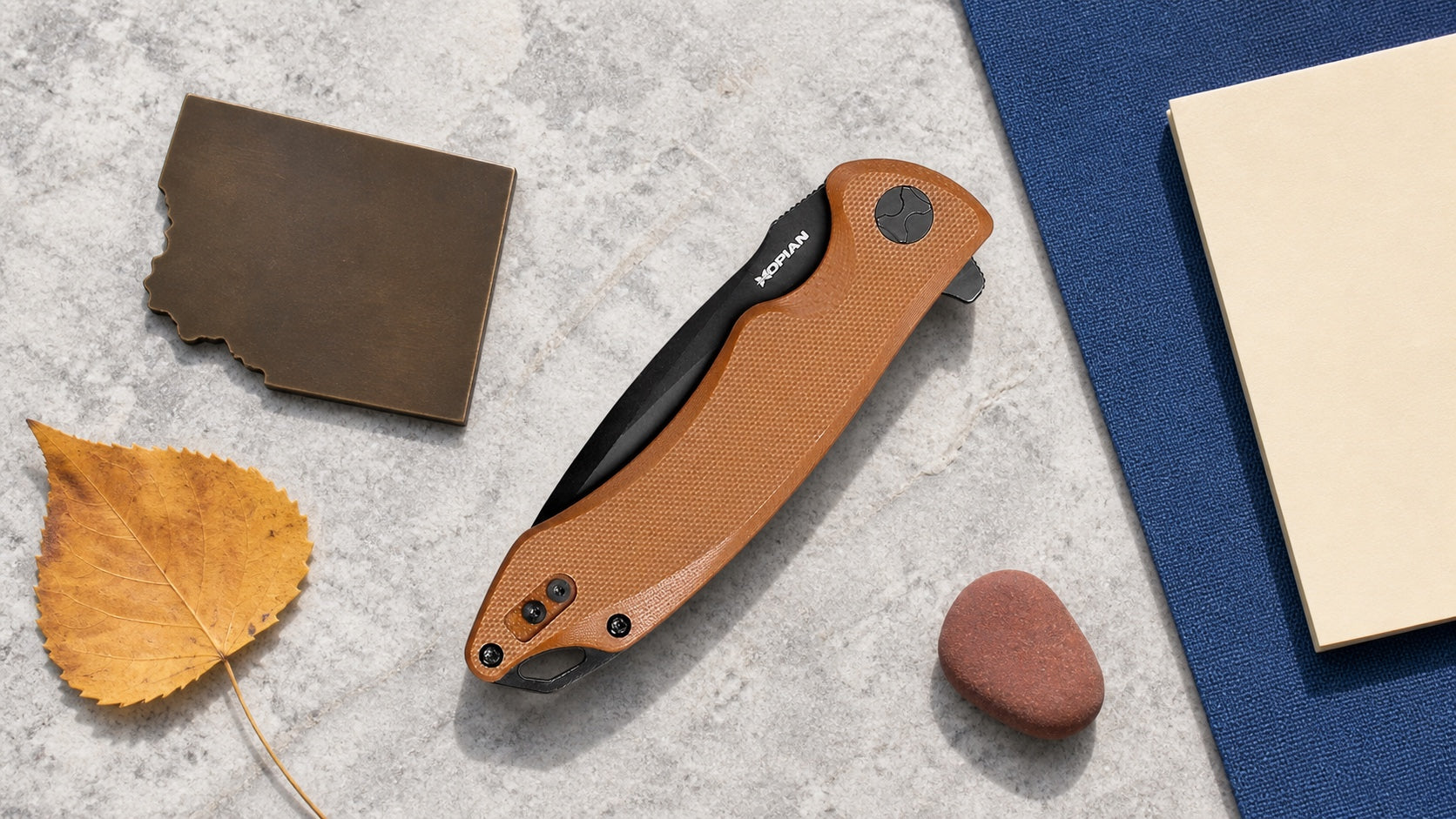 Closed brown HOPIAN Arcus knife in a neutral Colorado legal research scene