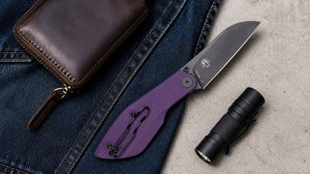 Open purple HOPIAN Periodic D2 knife with a wallet and flashlight