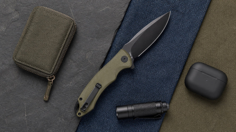Open green HOPIAN Arcus knife with a wallet, earbuds case, and flashlight