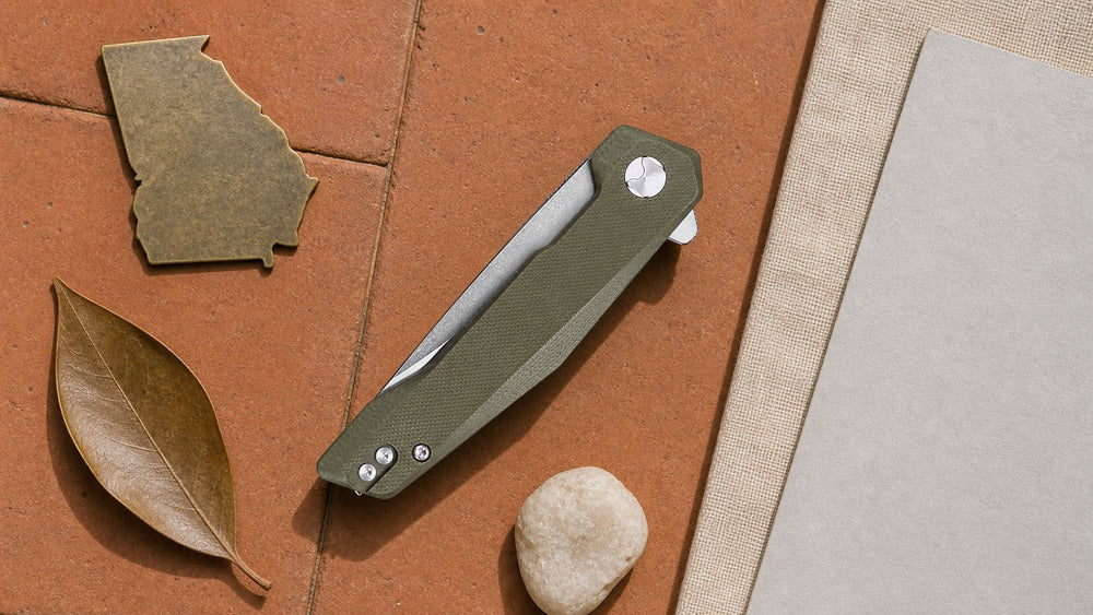 Closed green HOPIAN Vex knife in a neutral Georgia legal research scene