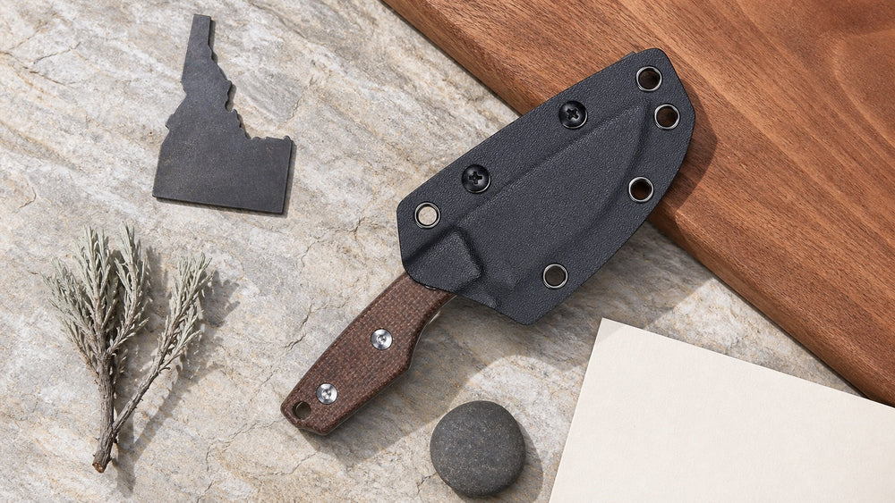 Sheathed brown HOPIAN Morrow knife in a neutral Idaho legal research scene