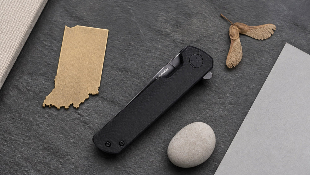 Closed black HOPIAN Clave knife in a neutral Indiana legal research scene