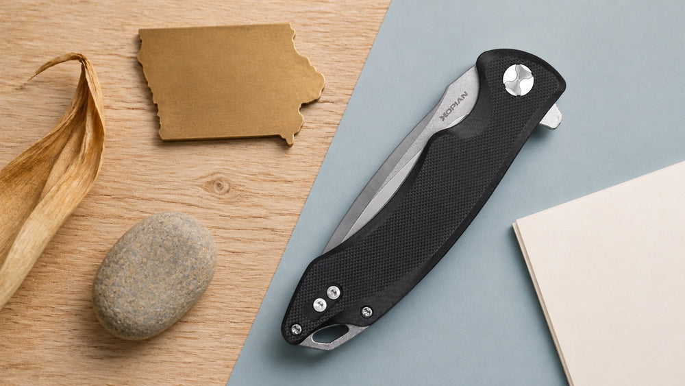 Closed black HOPIAN Arcus knife in a neutral Iowa legal research scene