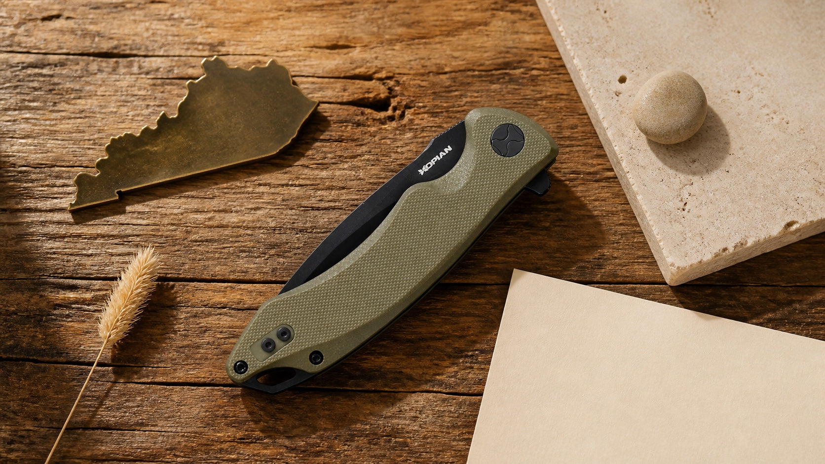 Closed green HOPIAN Arcus knife in a neutral Kentucky legal research scene