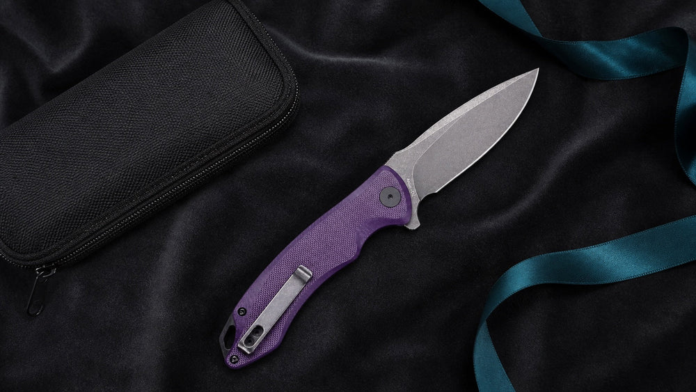 Open purple HOPIAN Arcus knife presented with a pouch and teal ribbon