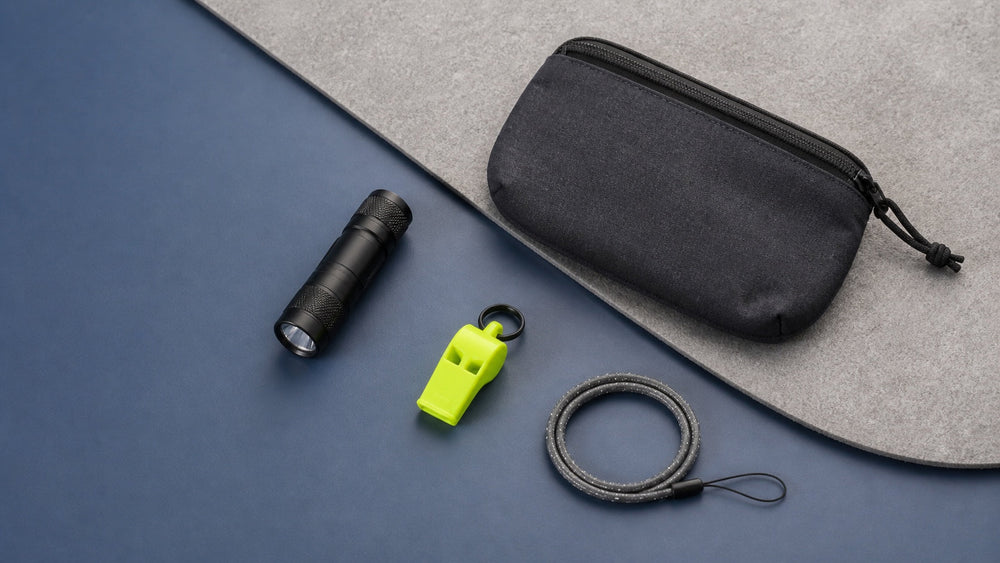 Flashlight, safety whistle, reflective cord, and pouch for everyday preparedness