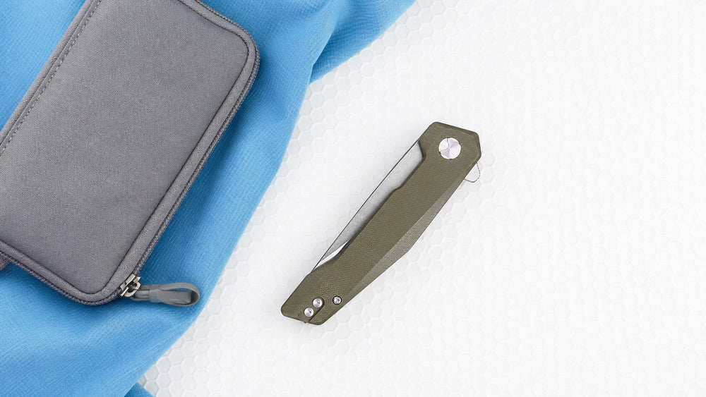 Closed green HOPIAN Vex knife with a compact pouch on lightweight materials