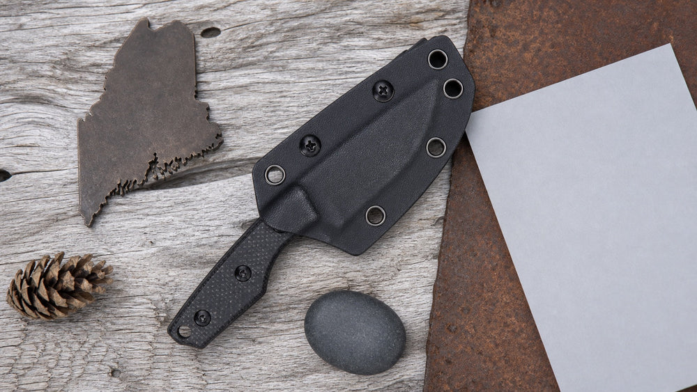 Sheathed black HOPIAN Morrow knife in a neutral Maine legal research scene