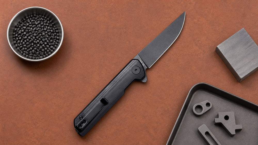 Black HOPIAN Clave folding knife beside metal injection molding sample parts