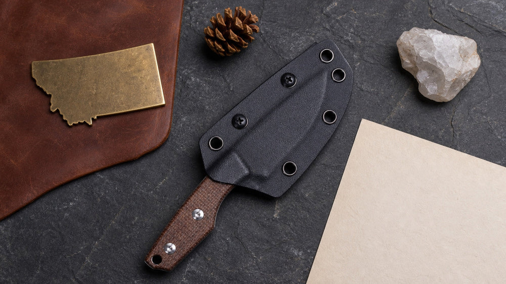 Sheathed brown HOPIAN Morrow knife in a neutral Montana legal research scene
