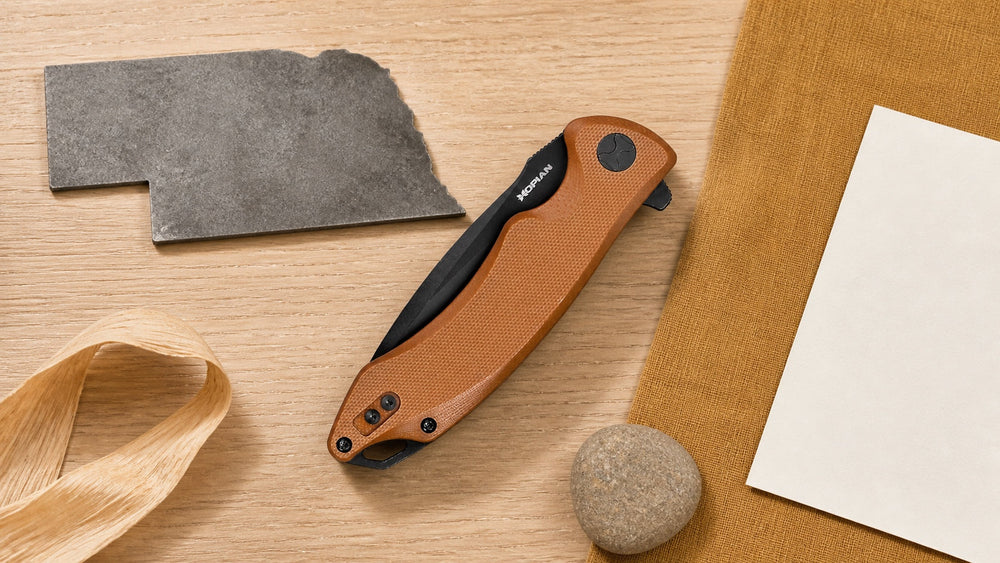 Closed brown HOPIAN Arcus knife in a neutral Nebraska legal research scene