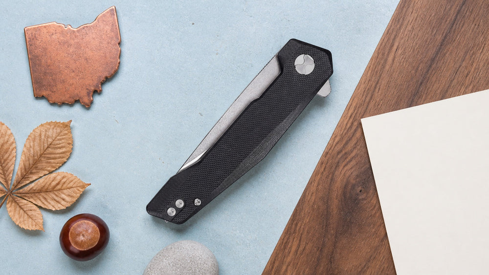 Closed black HOPIAN Vex knife in a neutral Ohio legal research scene