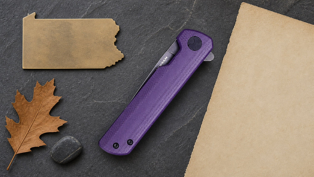 Closed purple HOPIAN Clave knife in a neutral Pennsylvania legal research scene