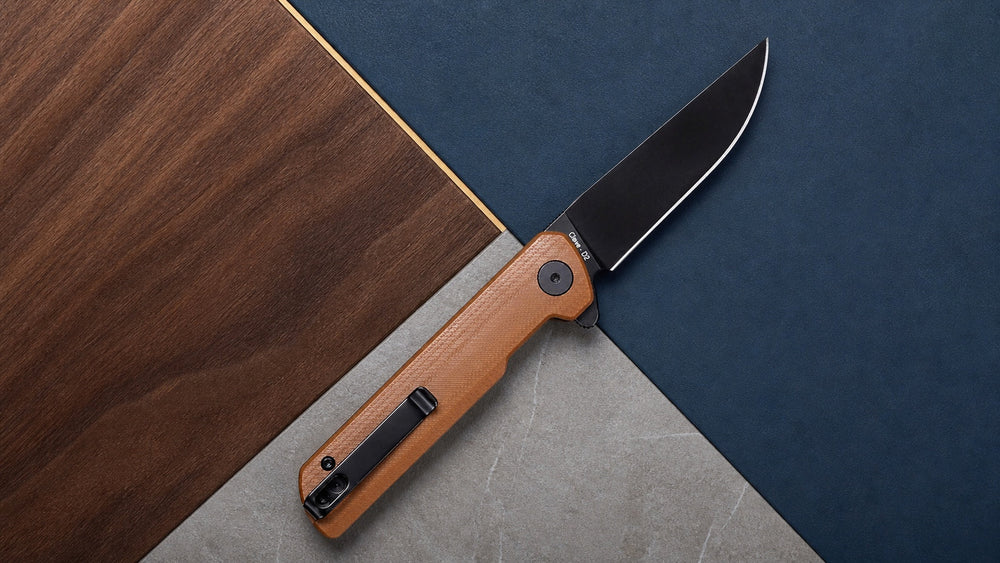 Open brown HOPIAN Clave knife across interlocking engineered surfaces