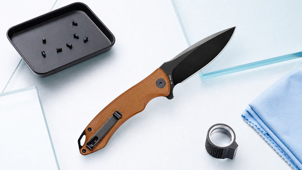 Brown HOPIAN Arcus folding knife on a bright overhead inspection table